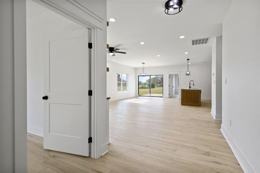 Hallway with recessed lighting and light wood-type flooring