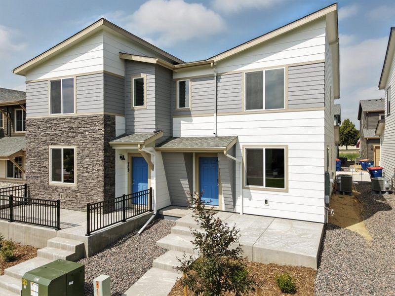 Front exterior of a new home in Pintail Commons at Johnstown Village, Johnstown, CO, highlighting curb appeal (Image 23).