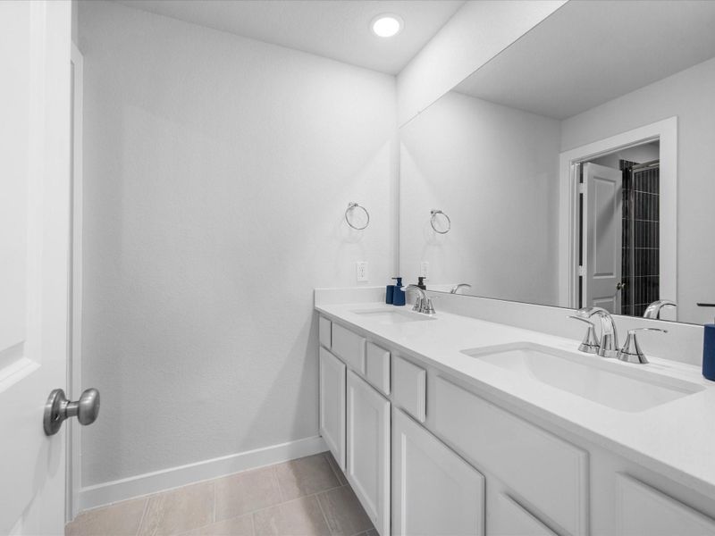Dual sinks in second floor bathroom. Upgraded tile an countertop