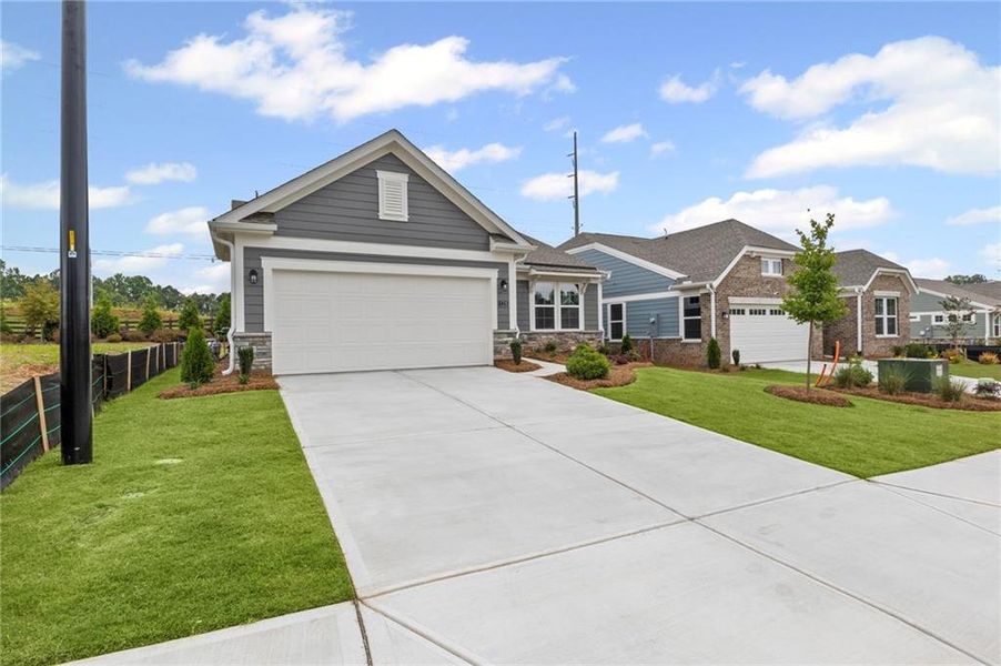 Front exterior of a new home in Laurel Farms, Dallas, GA, highlighting curb appeal (Image 2). Front exterior of a new home in Laurel Farms, Dallas, GA, highlighting curb appeal (Image 2).
