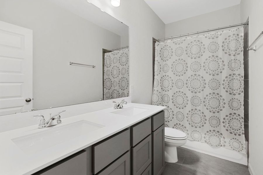 Upstairs bathroom featuring dual sinks and a large mirror, perfect for shared use. Upstairs bathroom featuring dual sinks and a large mirror, perfect for shared use.