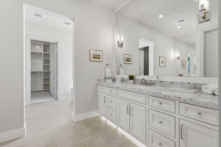 Designed like a private retreat,featuring Taj Mahal quartzitecounters on top of the built-invanities, dramatic mirror wall,ambient under-cabinet lightingand direct access to theincredible walk-in closet
