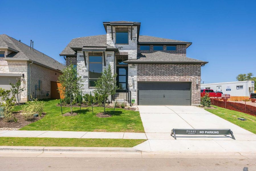 View of front of home with a front lawn, fence, a shingled roof, and driveway View of front of home with a front lawn, fence, a shingled roof, and driveway