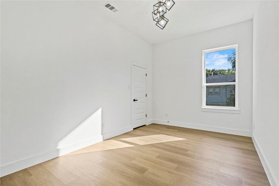 Empty room with light wood finished floors and baseboards