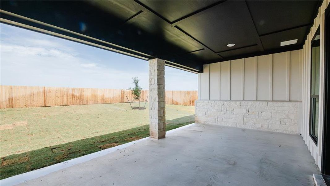 Fenced backyard with a patio area