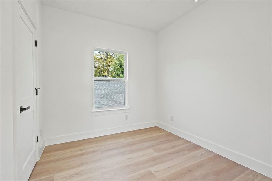 Unfurnished bedroom featuring light wood finished floors and a closet