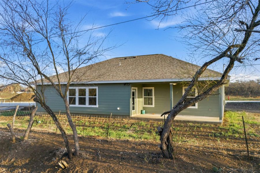 A newly constructed residence features an inviting covered patio, ideal for outdoor enjoyment.