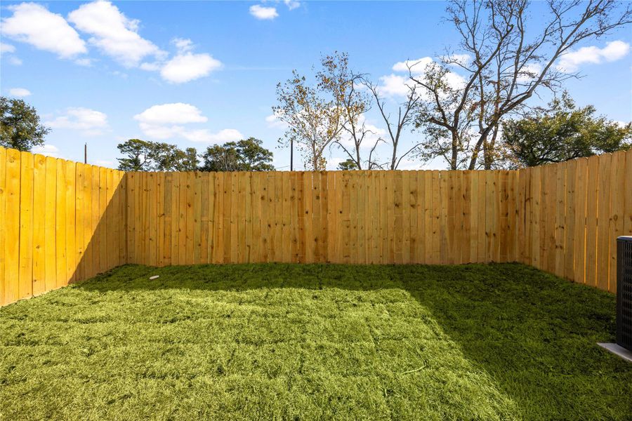 Fully fenced backyard featuring a grassy lawn and ample space for outdoor activities, pets, or future customization. Fully fenced backyard featuring a grassy lawn and ample space for outdoor activities, pets, or future customization.