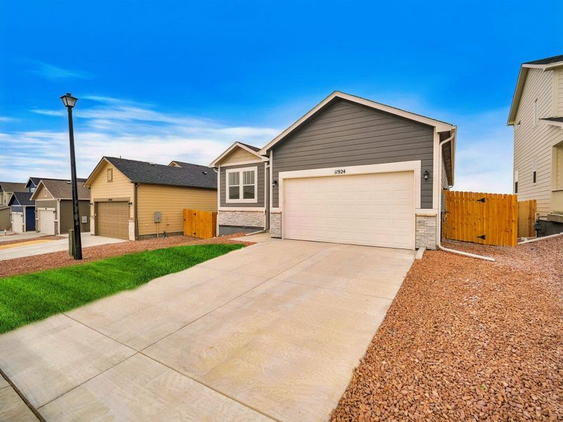 Front exterior of a new home in Ridge at Lorson Ranch, Colorado Springs, CO, highlighting curb appeal (Image 2).