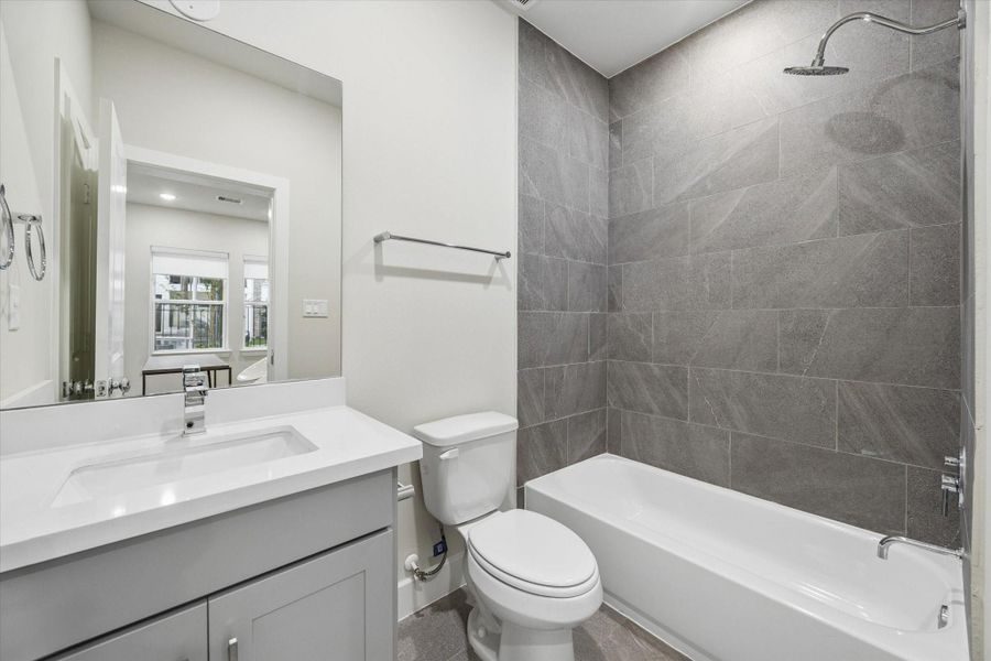 secondary bathroom that belongs to the 3rd bdrm on the third level. quartz counters, chrome finishes, porcelian tiles. Photo is of model at 6340, finishes are similar. secondary bathroom that belongs to the 3rd bdrm on the third level. quartz counters, chrome finishes, porcelian tiles. Photo is of model at 6340, finishes are similar.