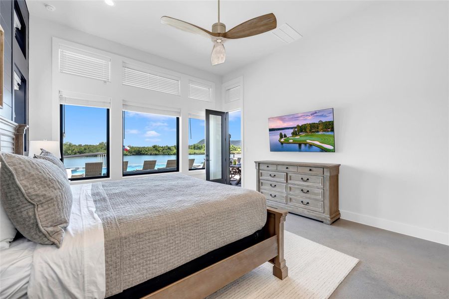 Gleaming concrete floors and massive windows framing scenic water views define this peaceful retreat.