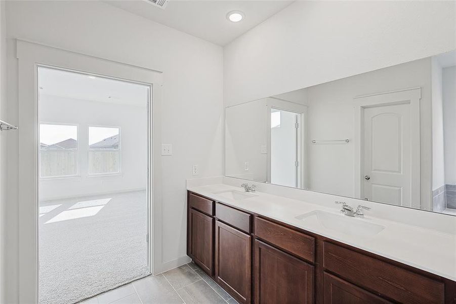 Bathroom featuring tile patterned flooring and vanity