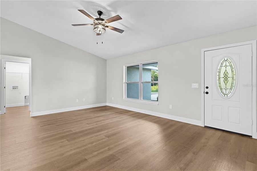 Front entrance and living area with laundry area in the background