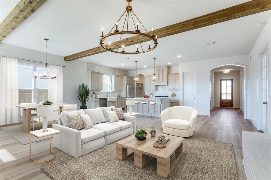 Living area featuring beamed ceiling, a chandelier, light wood-type flooring, arched walkways, and recessed lighting