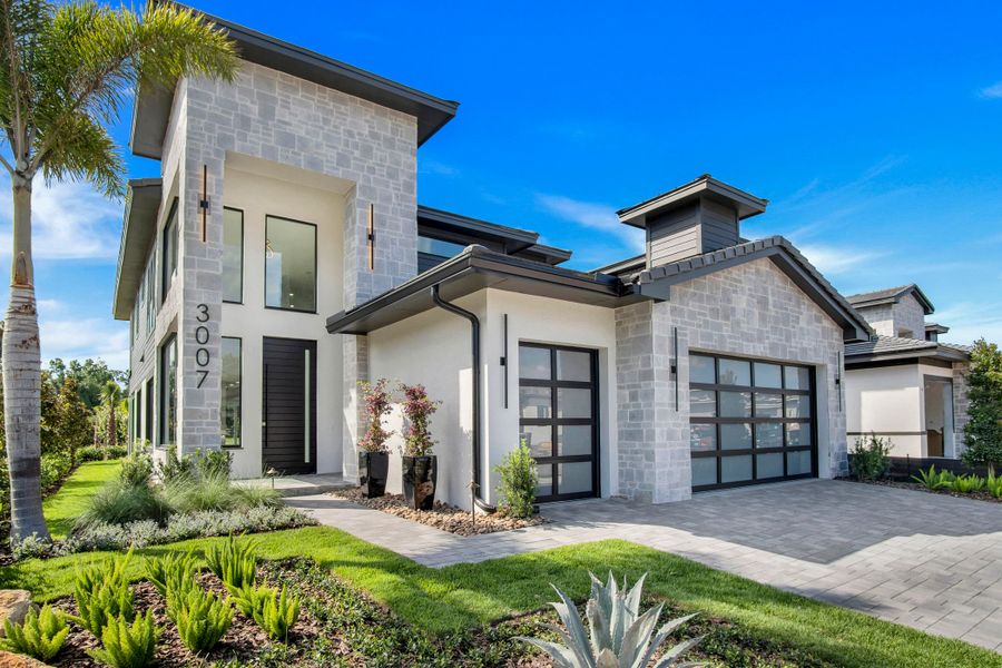 Front exterior of a new home in Hampton Green at Providence, Davenport, FL, highlighting curb appeal (Image 10).