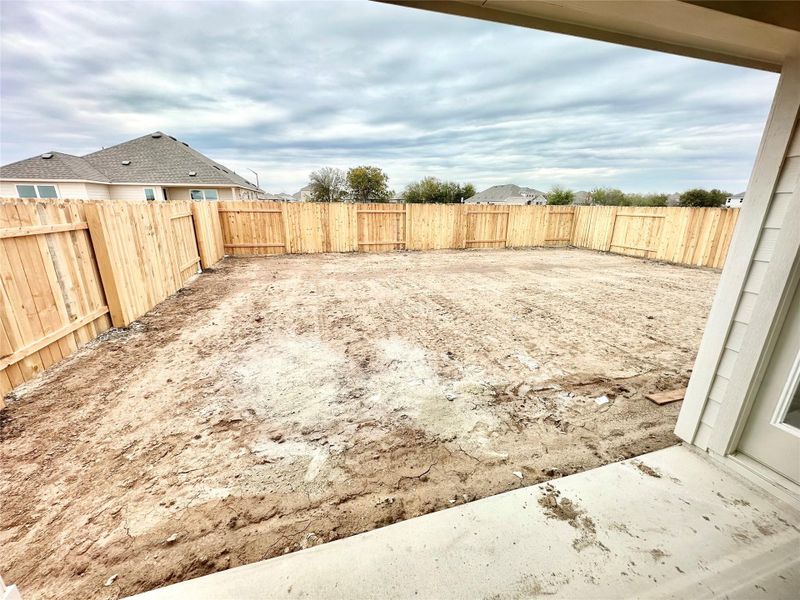 Fenced backyard with a patio area