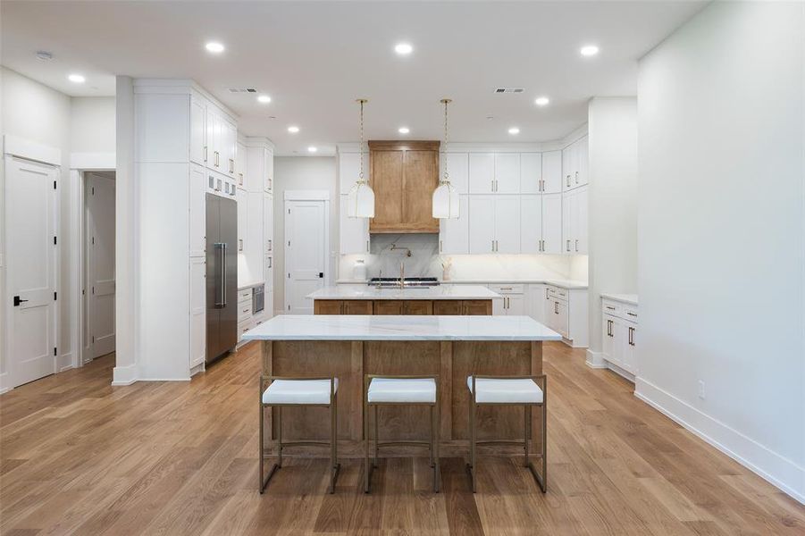 Kitchen with a kitchen island and light hardwood / wood-style flooring