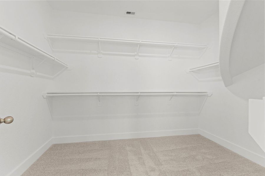 The spacious walk-in closet offers exceptional storage with multiple hanging sections, open shelving, and abundant room for organization. It’s the perfect balance of practicality and style—every fashion lover’s dream space.