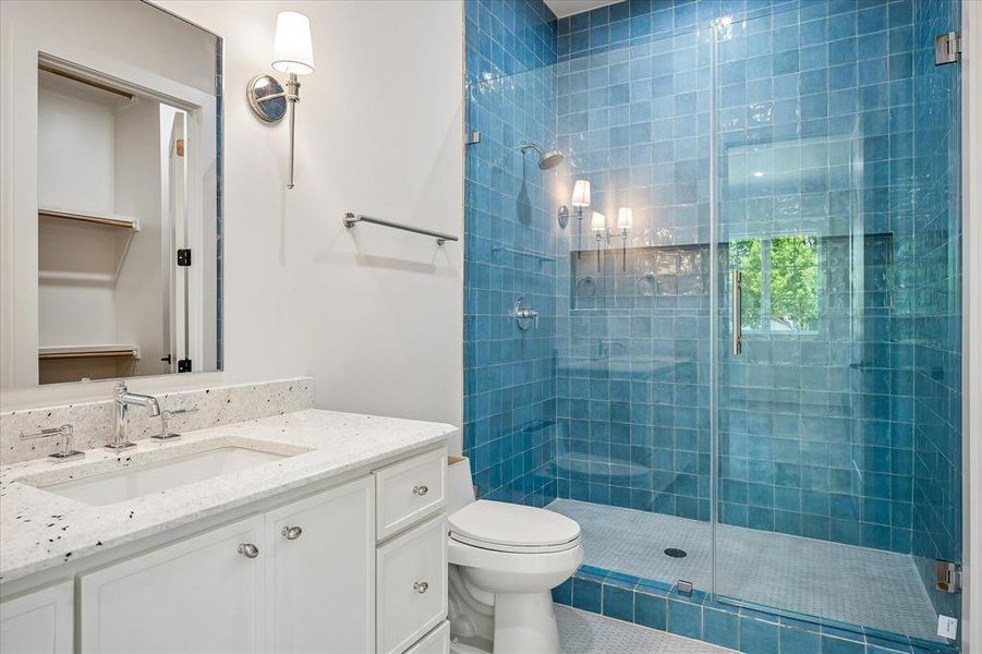 Bath, blue glazed tile shower, frameless glass enclosure, stone countertop, shower niche Bath, blue glazed tile shower, frameless glass enclosure, stone countertop, shower niche