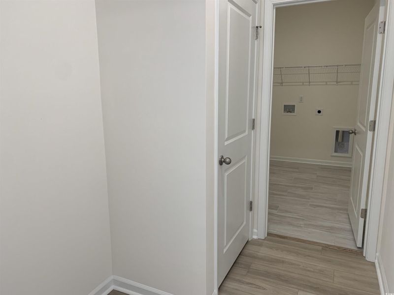 Washroom featuring washer hookup, light wood-style flooring, and electric dryer hookup