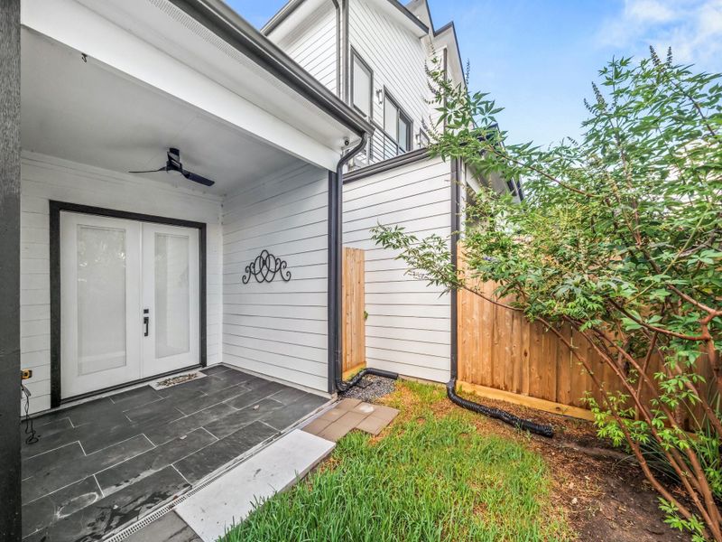 Rear covered patio, with ceiling fan, and security camera