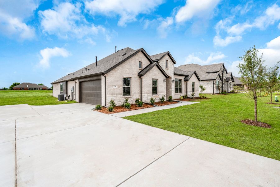 Front exterior of a new home in Mallard Point, Greenville, TX, highlighting curb appeal (Image 25).