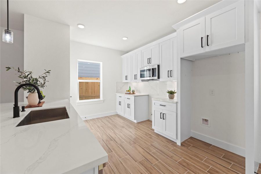 Boasting chic cabinets to the ceiling, there is an overflow of storage possibilities in the kitchen. Tuck away the many seldom used appliances on higher shelves and keep the everyday essentials within quick and easy reach! Boasting chic cabinets to the ceiling, there is an overflow of storage possibilities in the kitchen. Tuck away the many seldom used appliances on higher shelves and keep the everyday essentials within quick and easy reach!