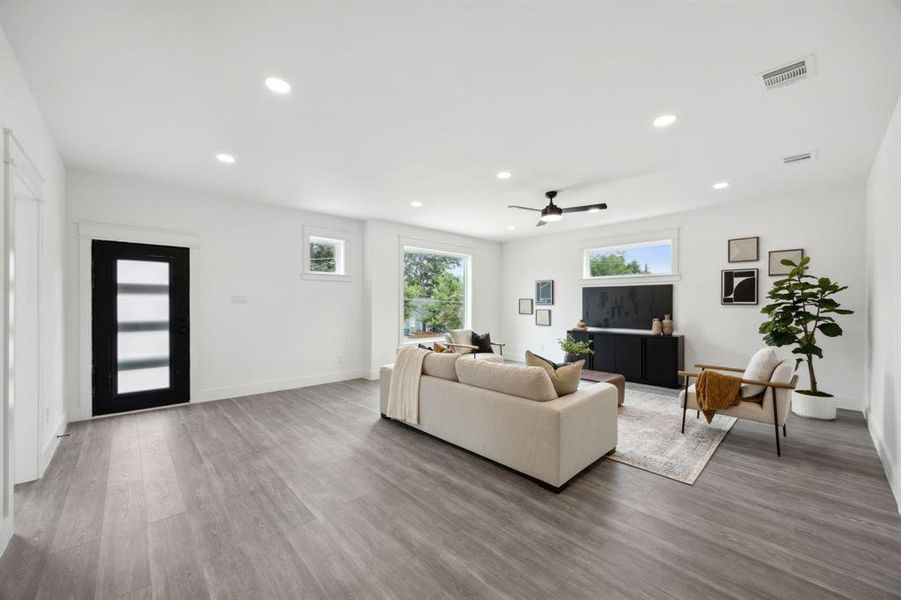 2nd floor living room featuring wood-style flooring and ceiling fan and door to front deck