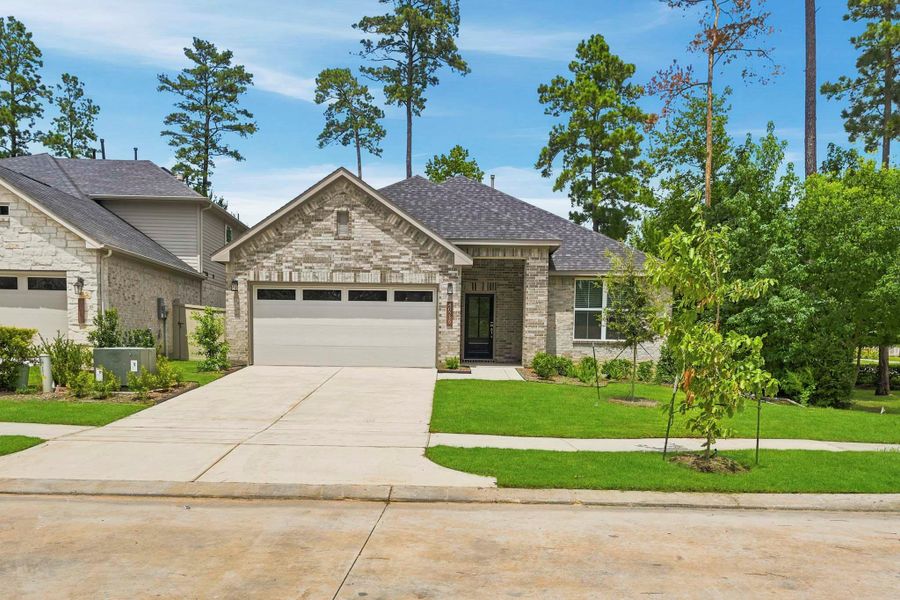 Front exterior of a new home in Audubon, Magnolia, TX, highlighting curb appeal (Image 2). Front exterior of a new home in Audubon, Magnolia, TX, highlighting curb appeal (Image 2).