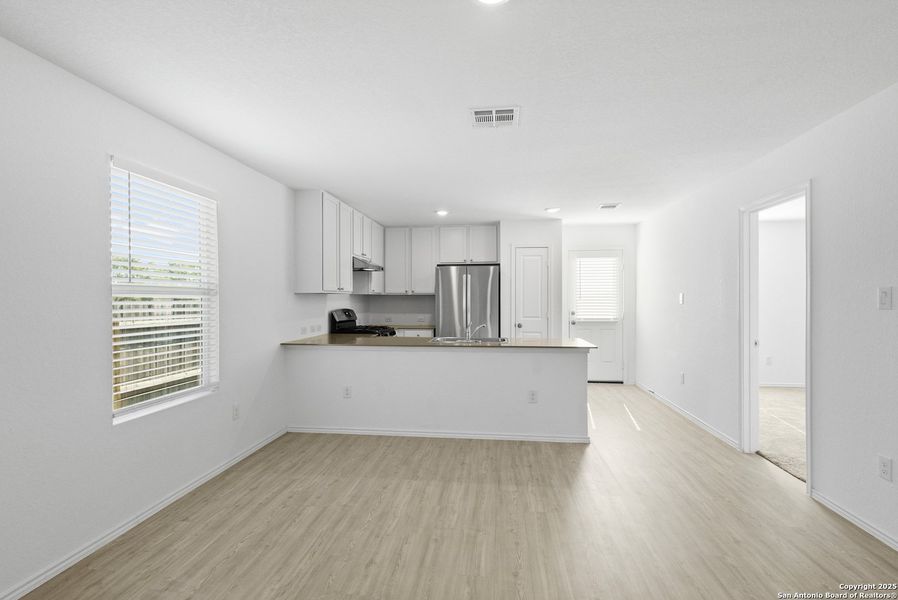 Spacious, unfurnished interior of a new home in Ruby Crossing: Cottage Collection, San Antonio (Image 9).