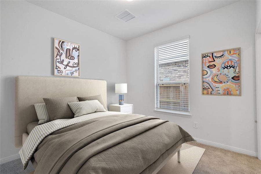 Secondary bedroom features plush carpet, neutral paint, lighting, large window with privacy blinds and ample sized closet space. This bedroom is on the first floor with private access to a secondary bathroom.