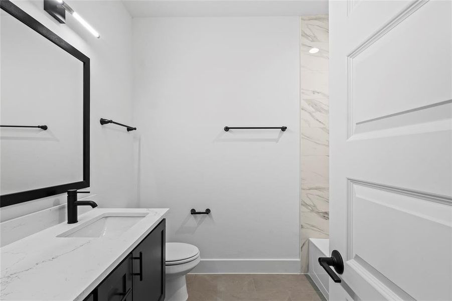 Full bathroom with tile patterned floors, vanity, toilet, and tub / shower combination