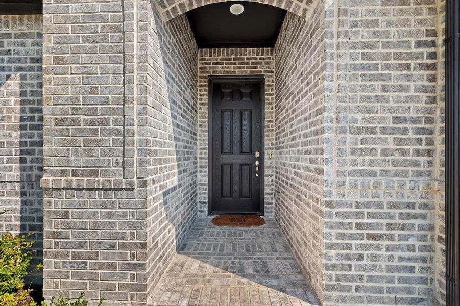 Doorway to property with brick siding Doorway to property with brick siding