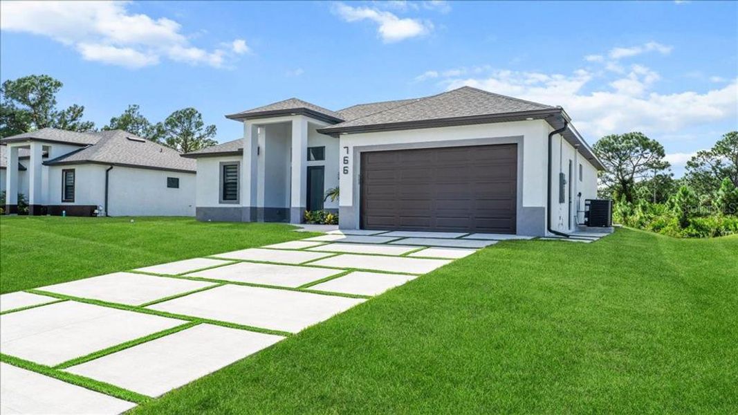 Front exterior of a new home in , Lehigh Acres, FL, highlighting curb appeal (Image 29).