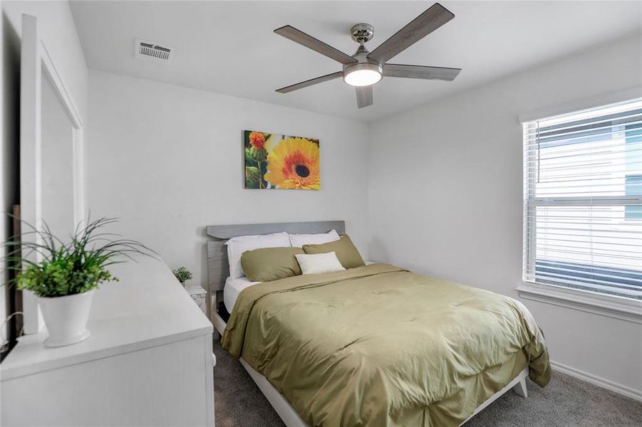 Bedroom featuring dark carpet and ceiling fan
