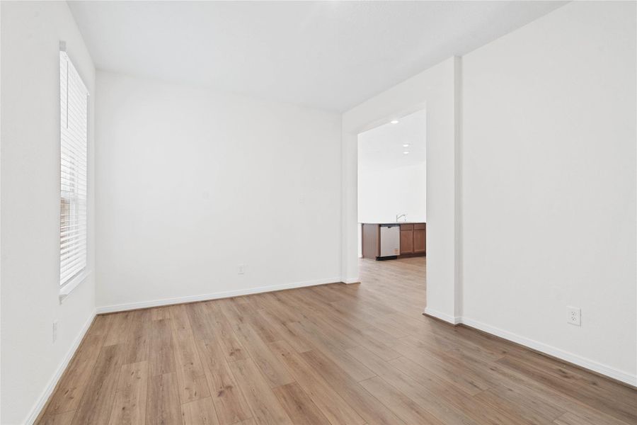 From this angle, the Den showcases its inviting openness through the wide entryway. From this angle, the Den showcases its inviting openness through the wide entryway.