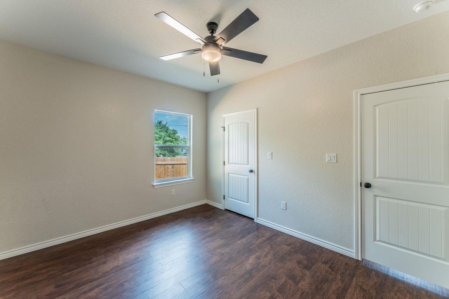 Interior room featuring wood-finish flooring and light-toned walls