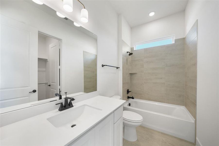 Full bathroom with shower / tub combination, vanity, and light tile patterned floors