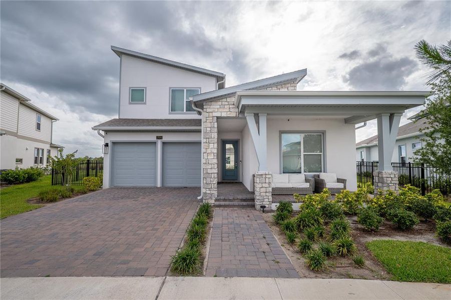 Front exterior of a new home in Laureate Park, Orlando, FL, highlighting curb appeal (Image 28). Front exterior of a new home in Laureate Park, Orlando, FL, highlighting curb appeal (Image 28).