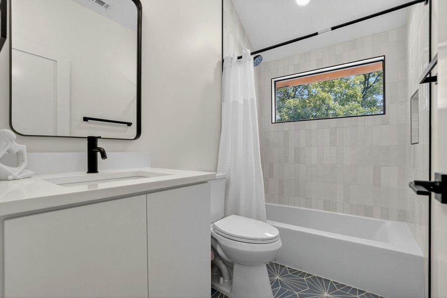 Full bathroom with shower / bathtub combination with curtain, vanity, and tile patterned flooring
