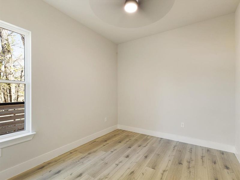 Spare room with wood finished floors and baseboards