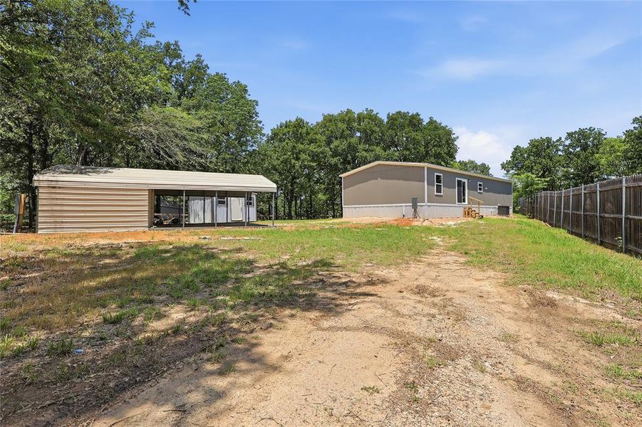 Driveway leading to home and covered parking.