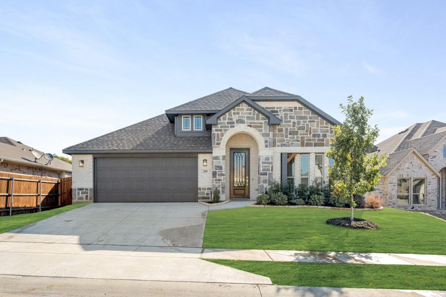 Single-story home with stone and brick exterior, two-car garage, arched entry, and manicured front lawn Single-story home with stone and brick exterior, two-car garage, arched entry, and manicured front lawn