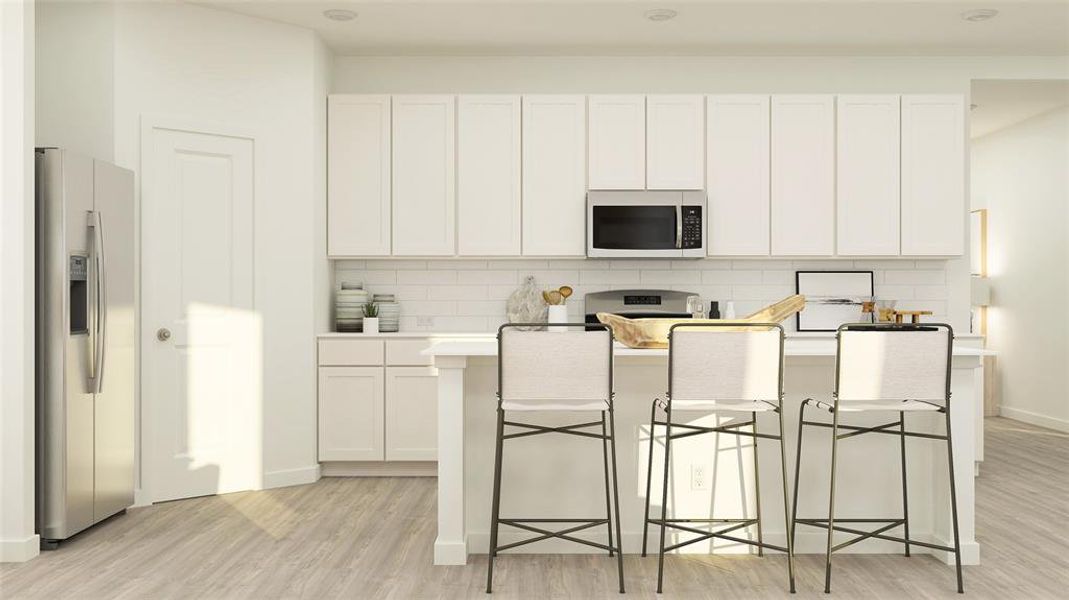 Kitchen with backsplash, a kitchen breakfast bar, white cabinetry, light hardwood / wood-style flooring, and stainless steel appliances