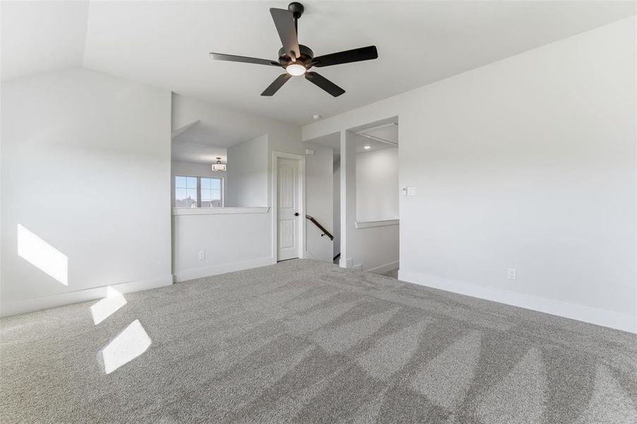 Empty room with carpet flooring and a ceiling fan