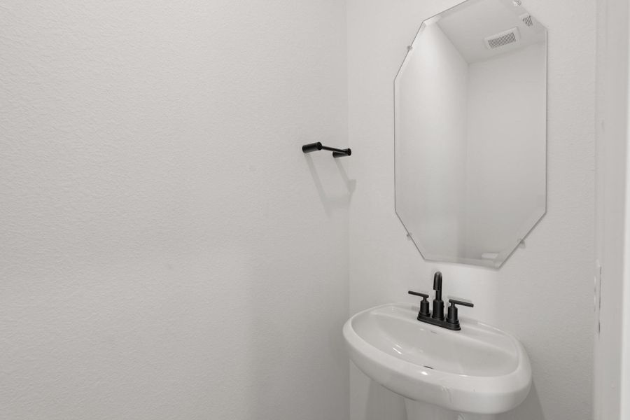 This charming home features a beautifully appointed half bath adjacent to the family room, perfect for welcoming guests and adding convenience to your daily life. This charming home features a beautifully appointed half bath adjacent to the family room, perfect for welcoming guests and adding convenience to your daily life.