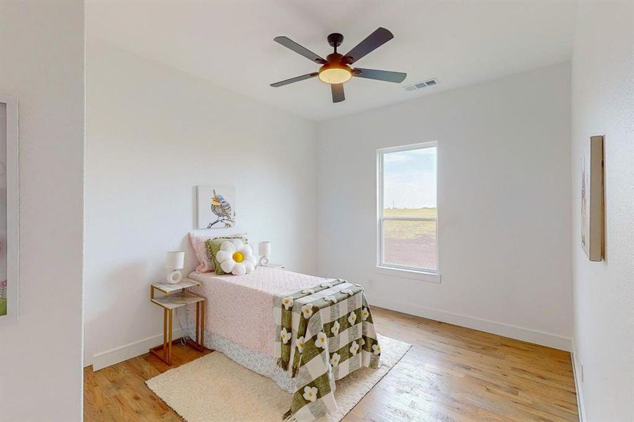 Bedroom featuring ceiling fan and light hardwood / wood-style flooring