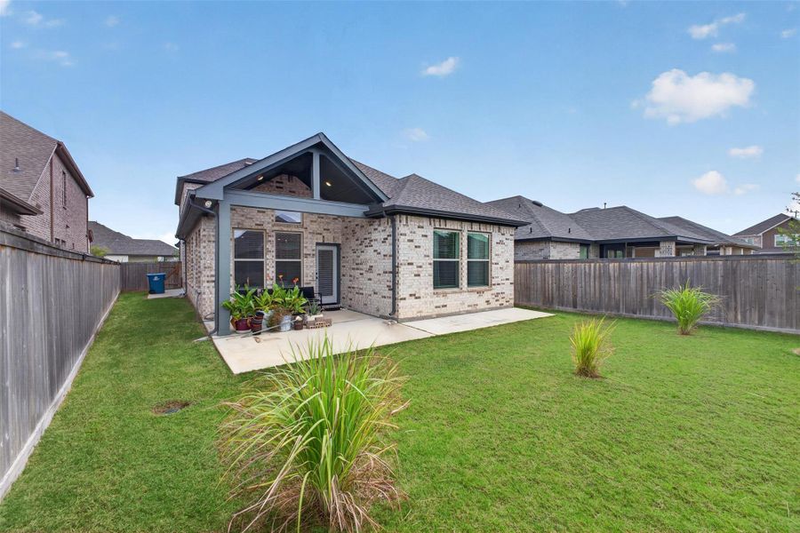 The covered backyard patio creates a comfortable extension of the home, offering the perfect place to enjoy morning coffee, weekend barbecues, or relaxing evenings with family and friends. Overlooking the fully fenced backyard, this inviting outdoor space is designed for year-round Texas living.