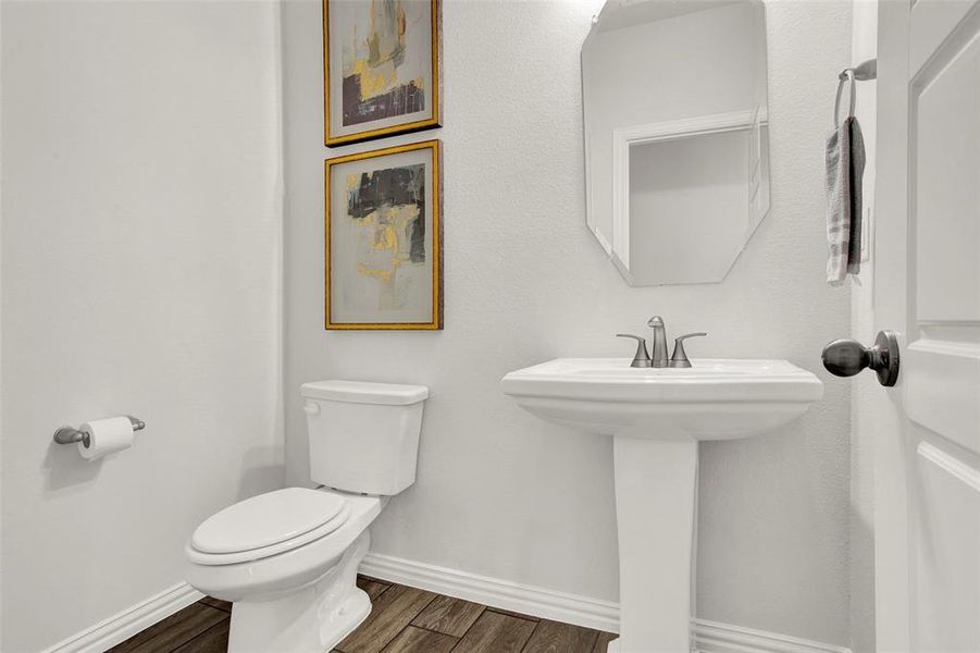 Bathroom with toilet and hardwood / wood-style flooring