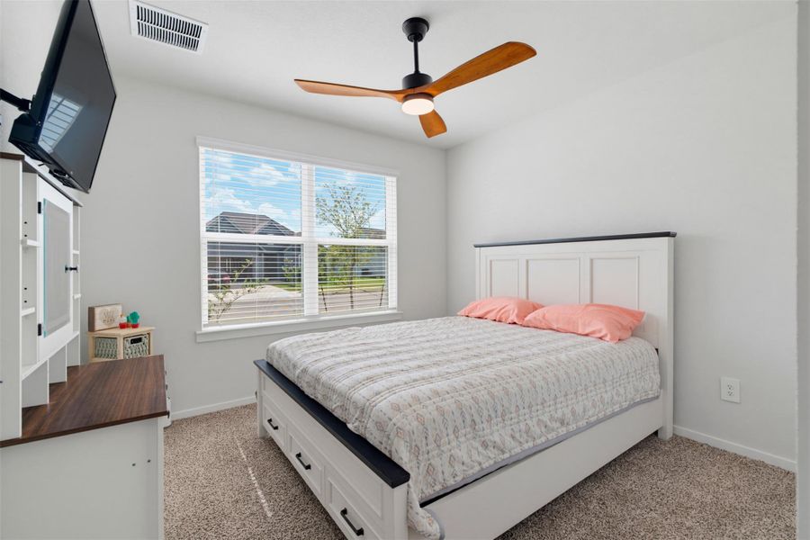 Plush carpeting and a large window facing the neighborhood define this comfortable bedroom. Plush carpeting and a large window facing the neighborhood define this comfortable bedroom.